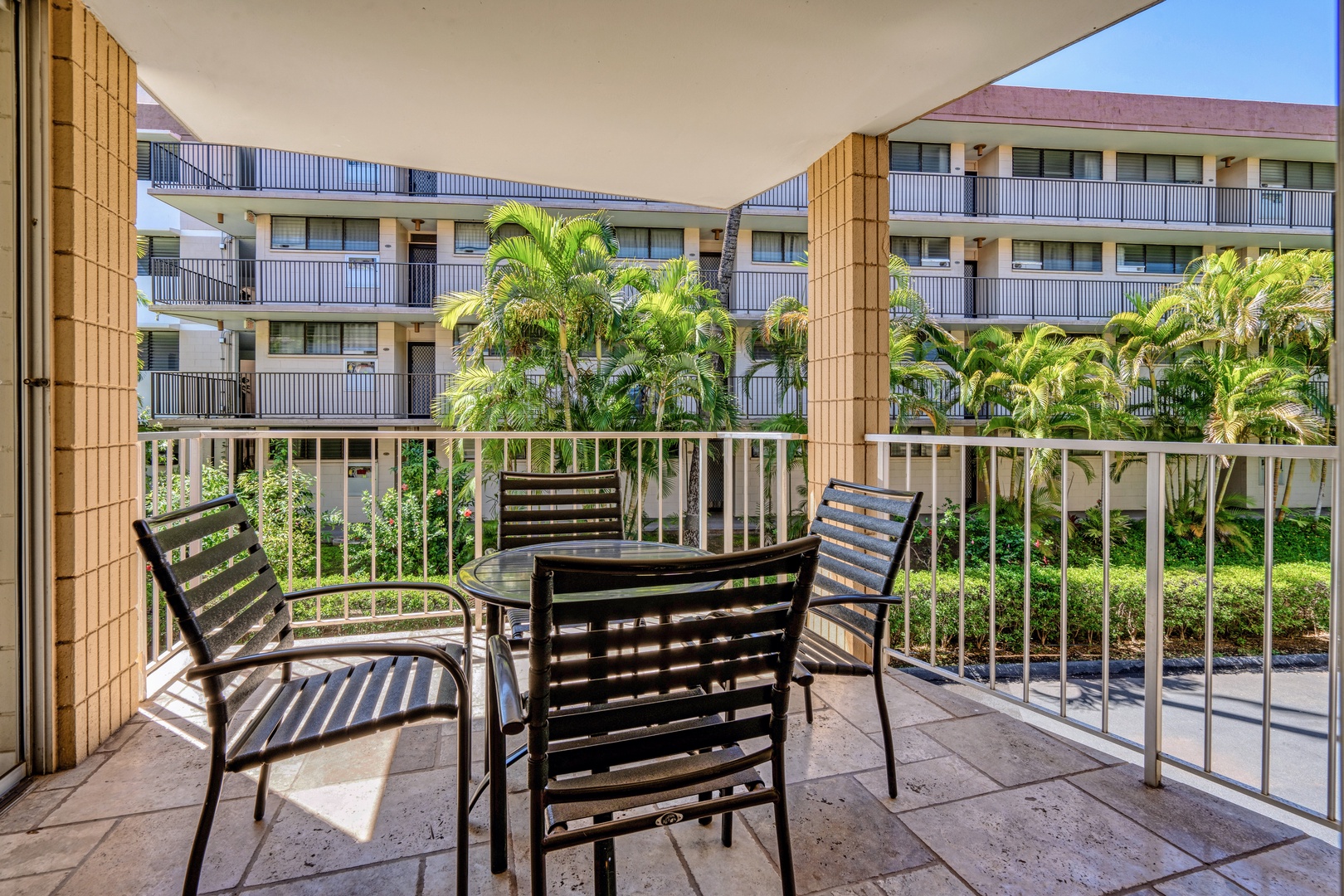Kihei Vacation Rentals, Haleakala Shores A206 - A comfortable table setting makes this private lanai just right for a slow breakfast among the palms.