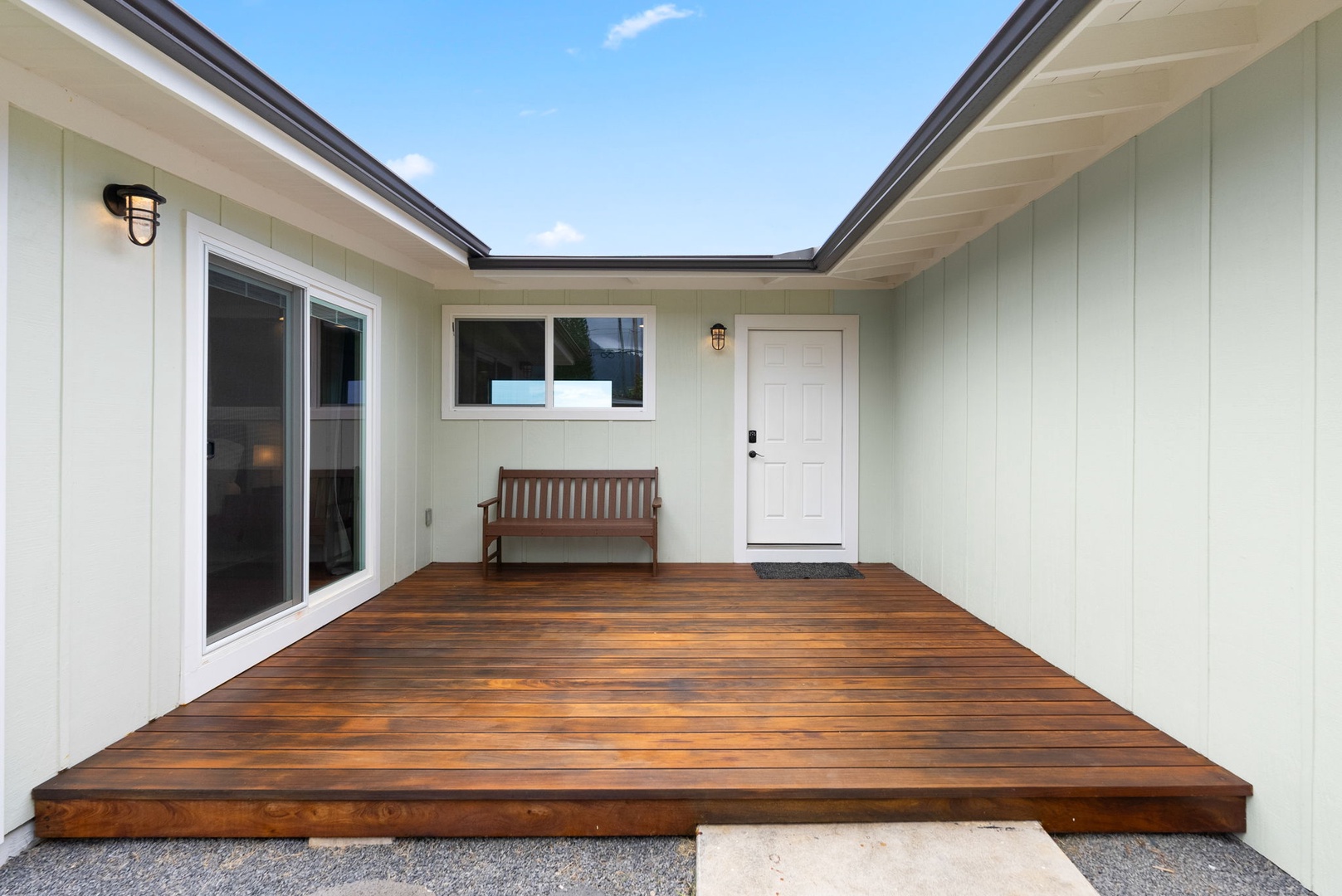 Waialua Vacation Rentals, Mokuleia Beach Villa** - The expansive deck offers serene tropical views.