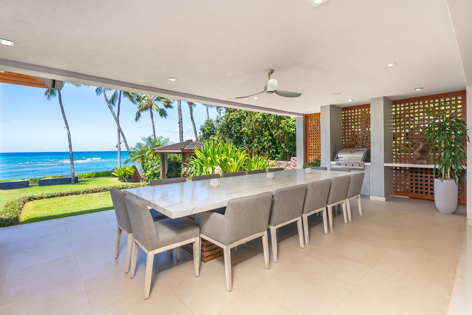 Honolulu Vacation Rentals, Diamond Head Beachfront Estate - Gather around this elegant outdoor dining table where ocean breezes meet tropical views—a perfect spot to share memorable meals with loved ones, framed by swaying palms and endless blue waters.