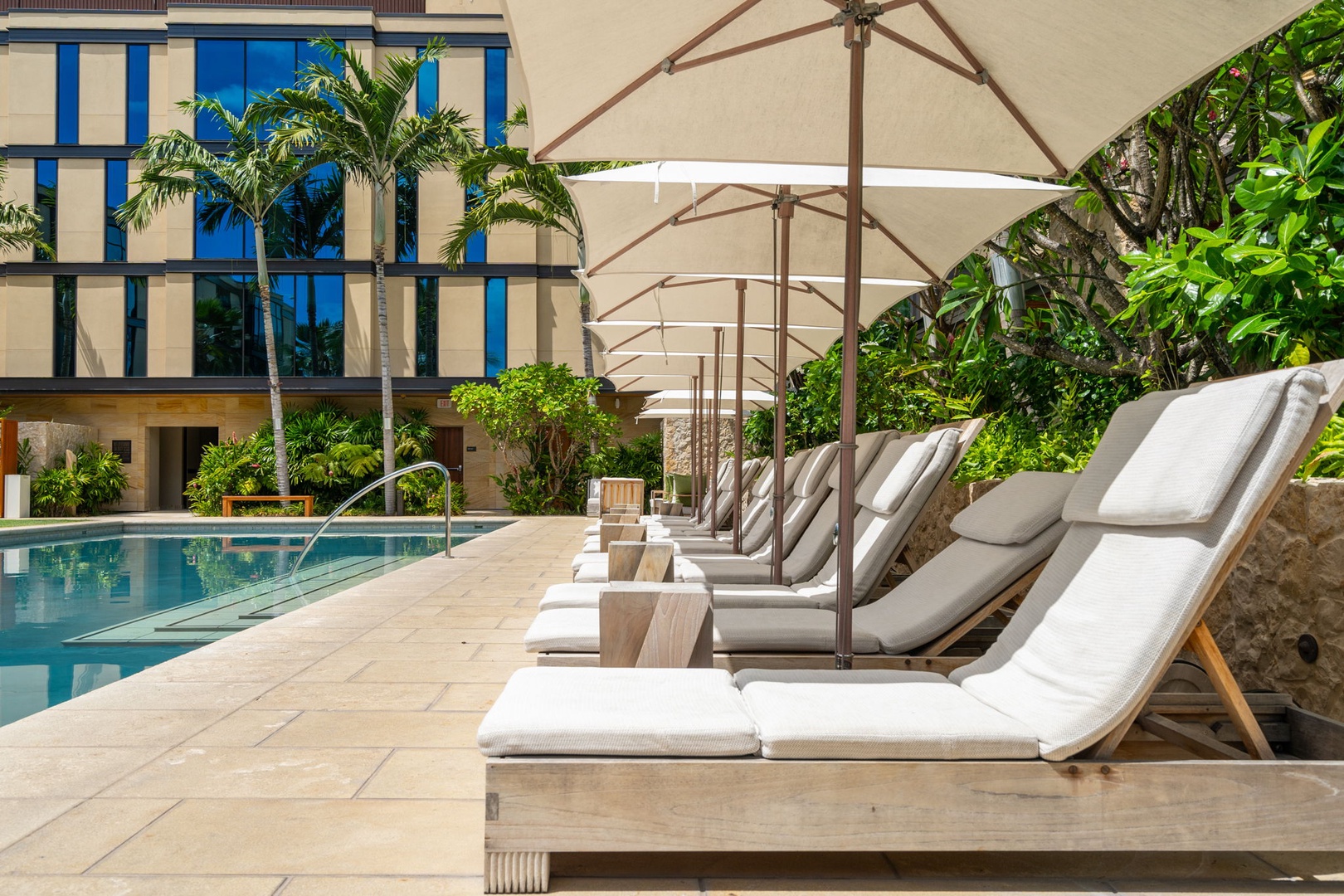 Honolulu Vacation Rentals, Park Lane Getaway - Poolside loungers under shaded umbrellas – perfect for sun-kissed relaxation.