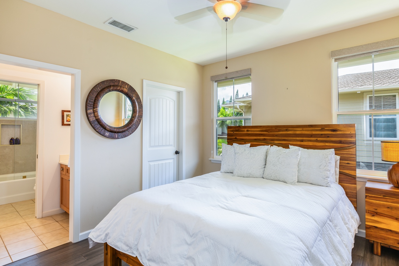 Princeville Vacation Rentals, Pualani Villa - Third bedroom features a queen-size bed, natural light, and an ensuite bathroom for added convenience.