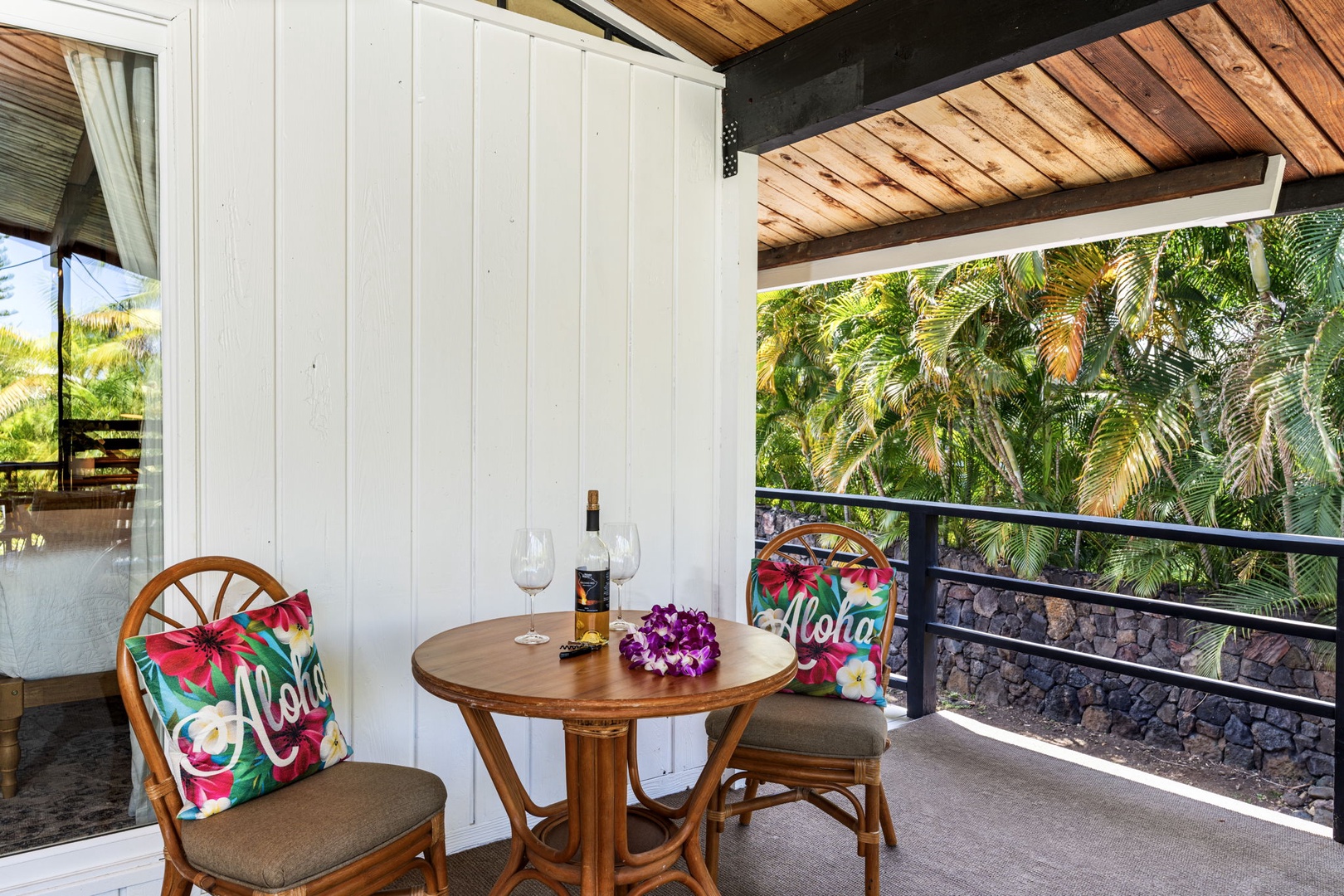 Kailua Kona Vacation Rentals, Mai Tai Manor - Savor local wine on your private balcony, surrounded by swaying palms and tropical charm with colorful Hawaiian touches.