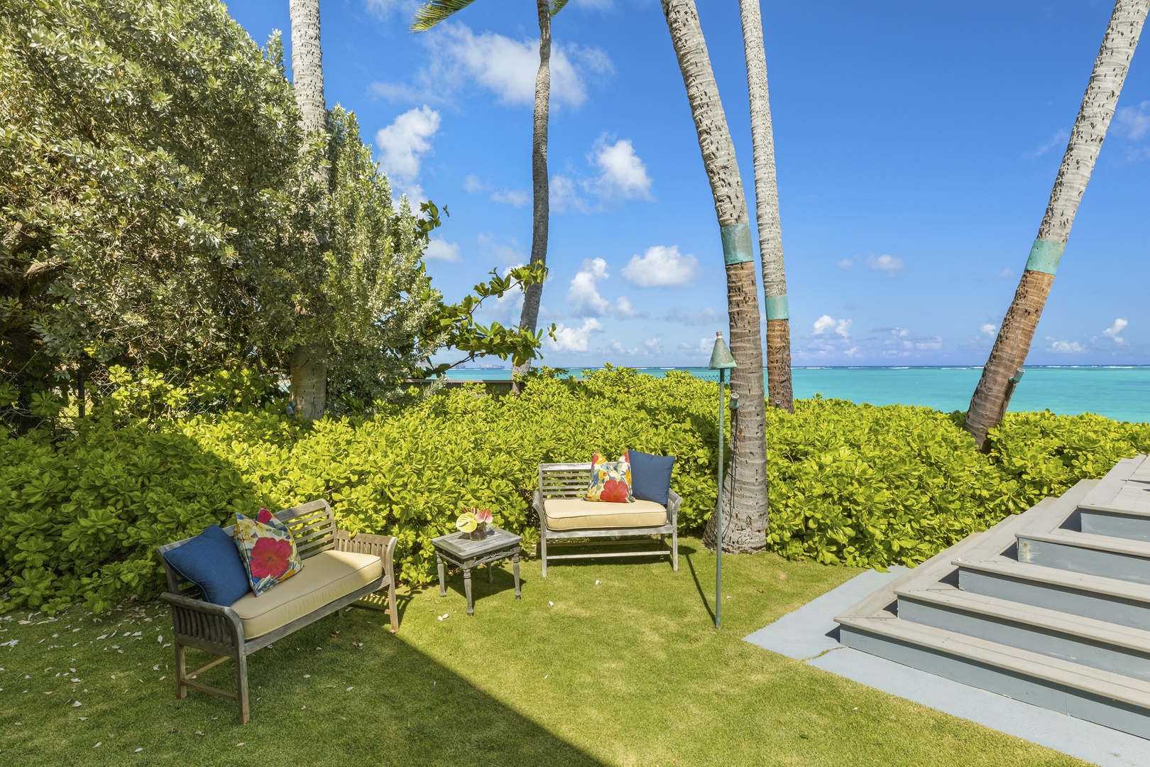 Kailua Vacation Rentals, Mokulua Sunrise - The home’s backyard features an elevated oceanside lanai where chaise lounge chairs, a hammock, and swaying palms beckon you to soak up some tropical sun.