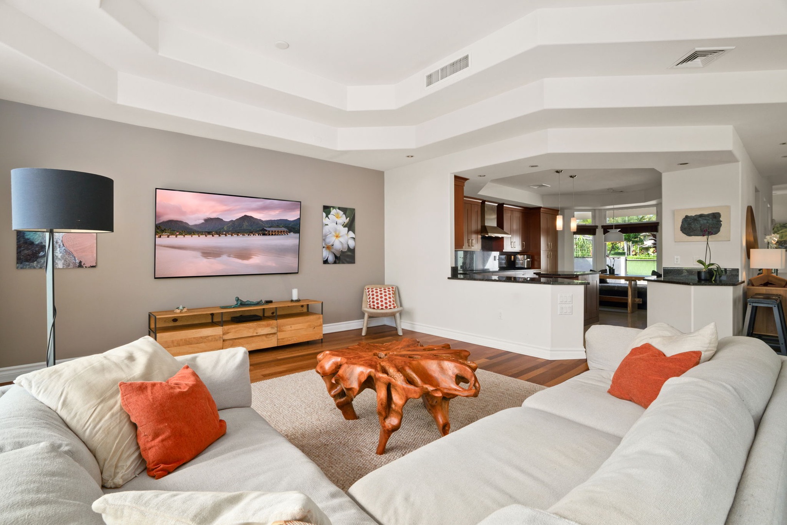 Princeville Vacation Rentals, Kaiulani #8 - Settle in for a movie in the living area, centered around a sculptural wood coffee table and comfortable sectional.