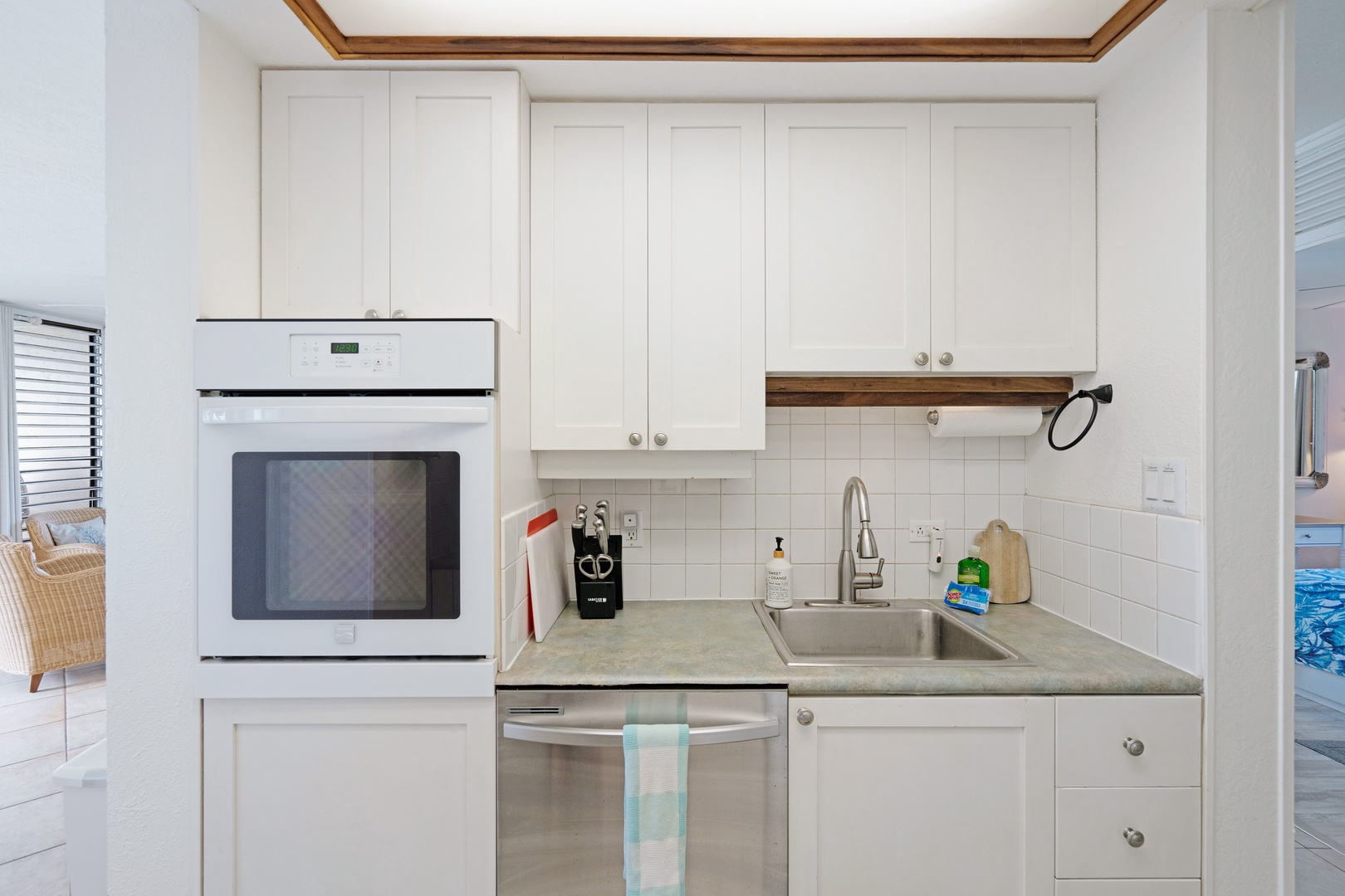 Kihei Vacation Rentals, Punahoa Beach 205 - Cooking in feels like part of the vacation in a bright white kitchen with the wall oven at eye level.