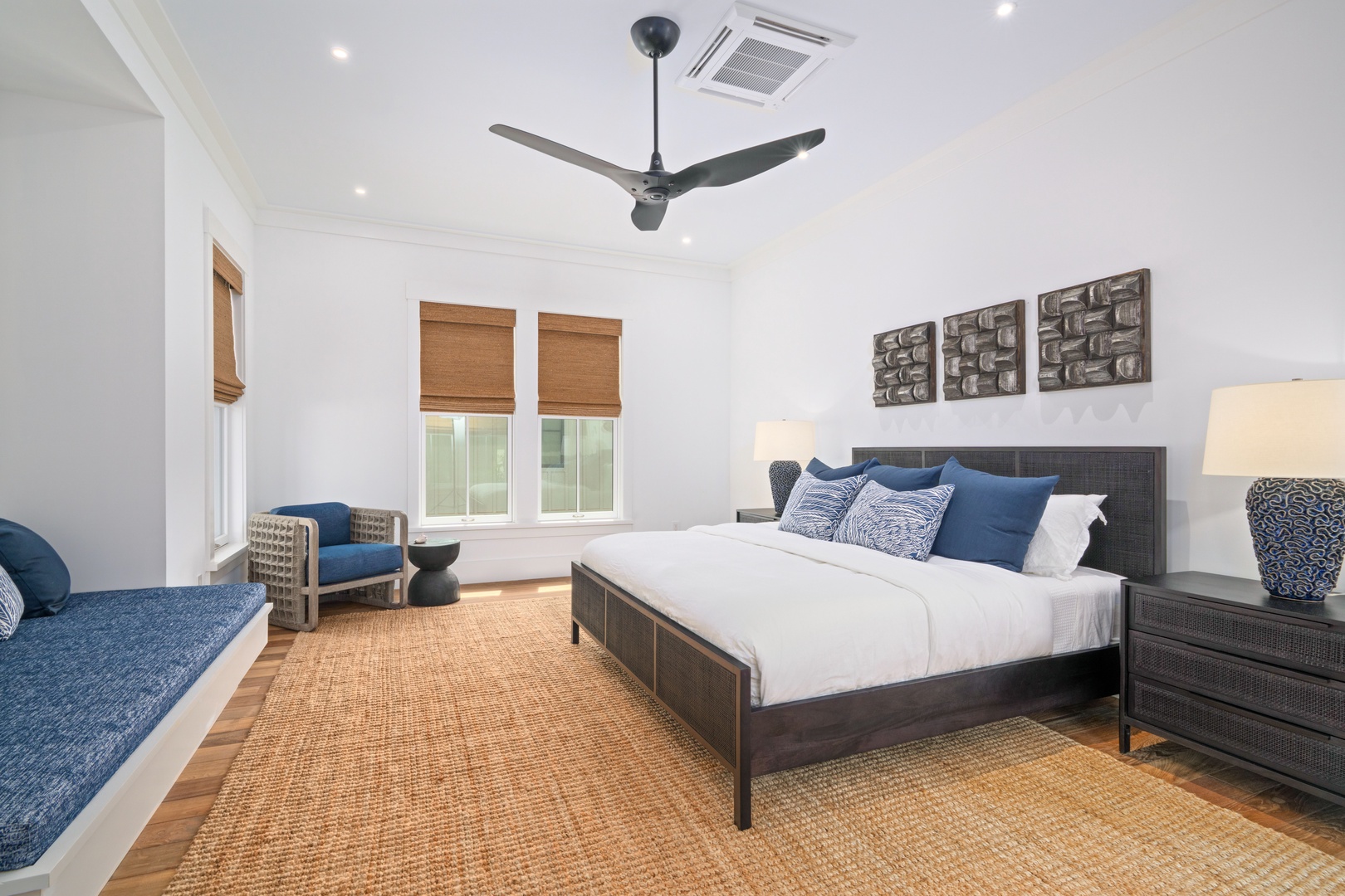 Koloa Vacation Rentals, Makani Kai - A king bed, a corner chair, and soft light through the shades.