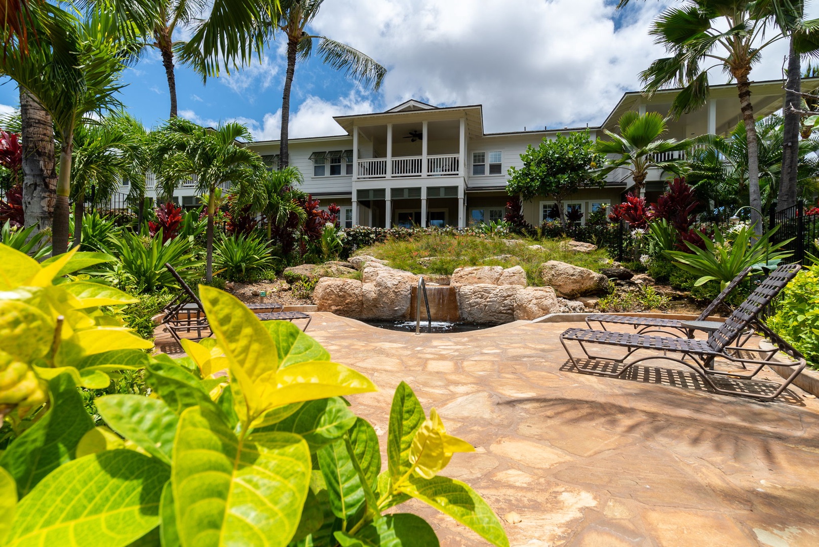 Kapolei Vacation Rentals, Coconut Plantation 1080-4 - Tropical planting thick around the pool deck, green and layered in every direction.