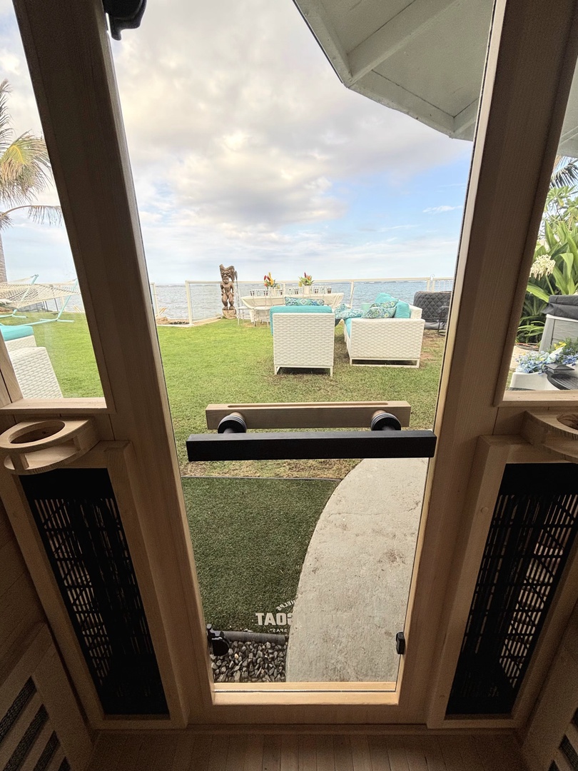 Hauula Vacation Rentals, Private Beach Paradise - View from inside the sauna, the lawn and the water line up like a painting.