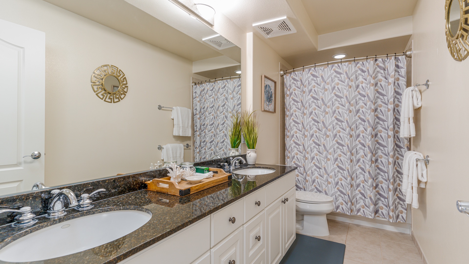Kapolei Vacation Rentals, Ko Olina Kai 1027A - The primary guest bathroom with a double vanity and shower.
