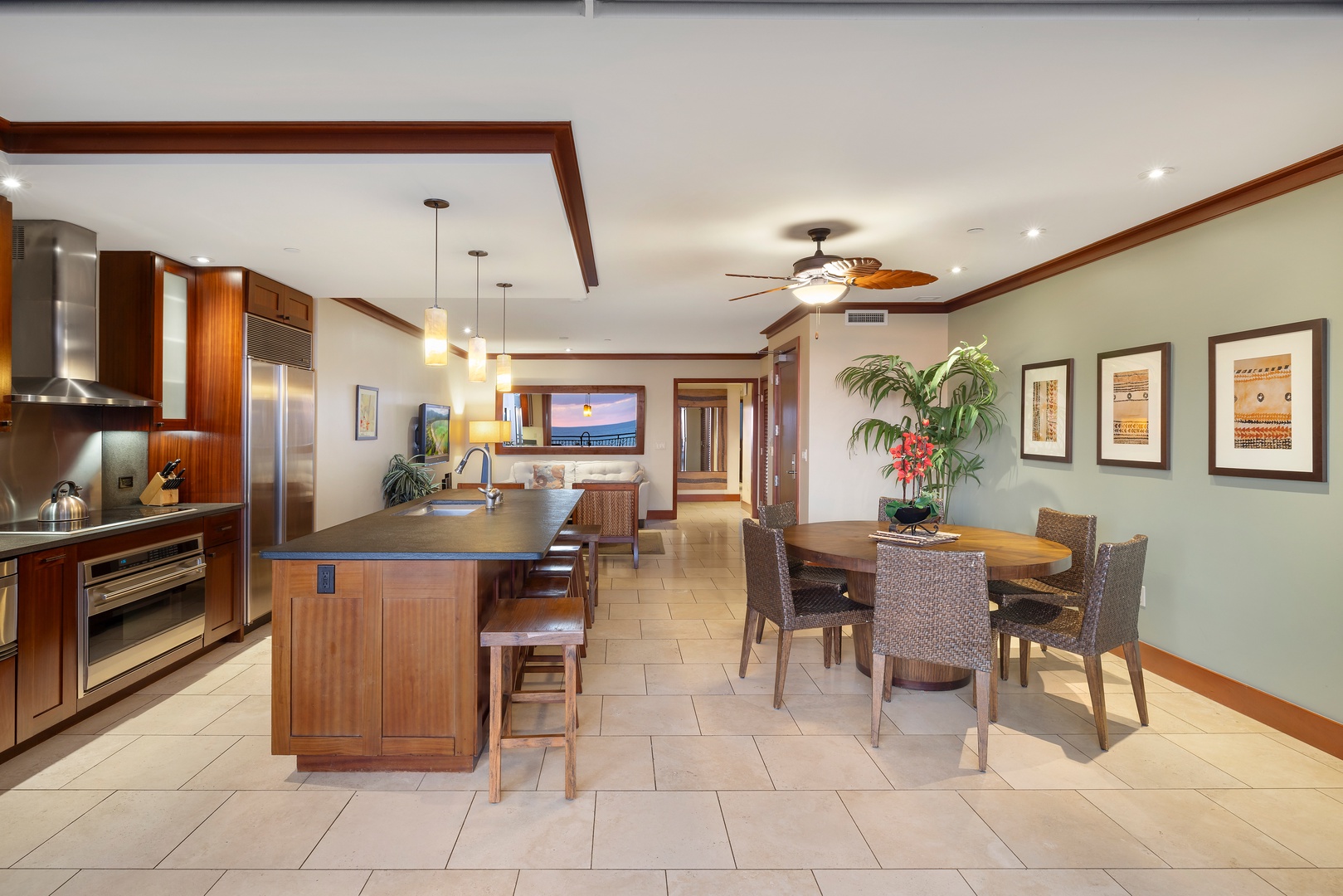 Kapolei Vacation Rentals, Ko Olina Beach Villas O1006 - Modern kitchen and dining area with a glimpse into the inviting living room beyond.
