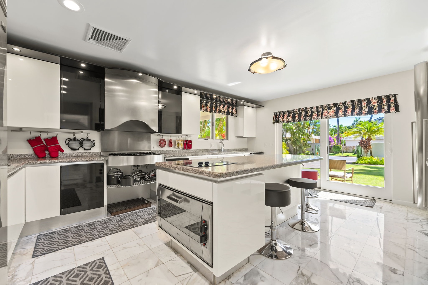 Honolulu Vacation Rentals, Kahala Oasis - Spacious, fully equipped kitchen with modern appliances, an island, and bar seating—perfect for entertaining.