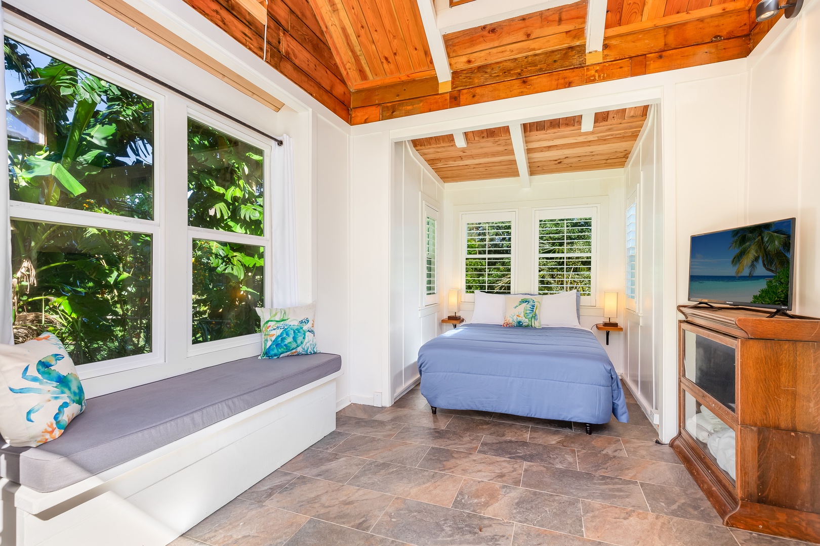 Haleiwa Vacation Rentals, Mele Makana - Guest bedroom 8 presents a queen bed & window nook with comfy bench