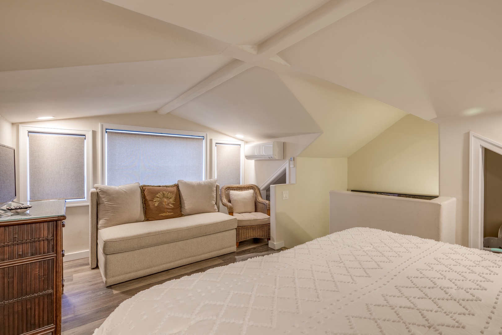 Lahaina Vacation Rentals, Puamana 240-3 - A beautifully designed guest bedroom with a cozy reading nook and serene ambiance.