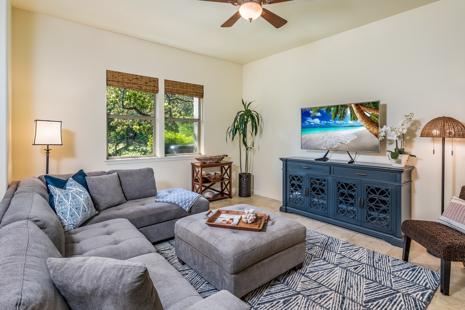Kamuela Vacation Rentals, Mauna Lani Fairways #204 - Relax in the stylish living room with flat-screen TV, plush sectional seating, and tranquil fairway-facing windows.