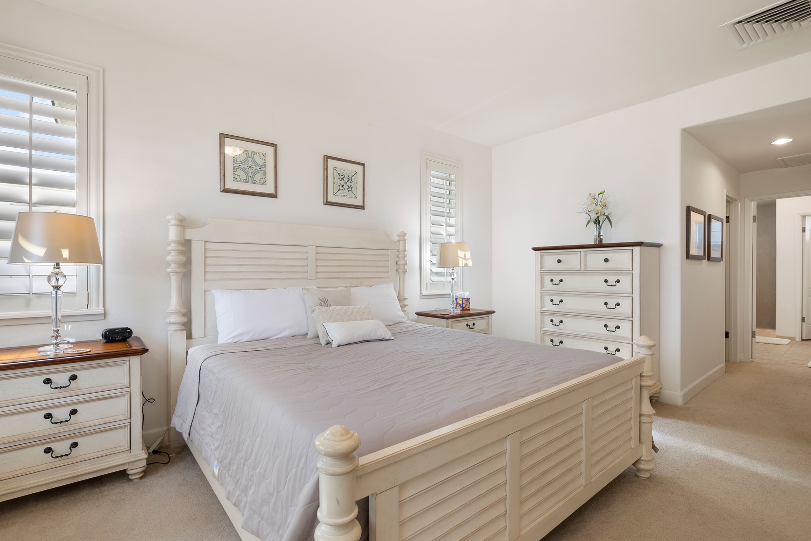 Drift into peaceful sleep in your elegantly furnished bedroom, complete with crisp linens and charming coastal-style furniture for ultimate relaxation.
