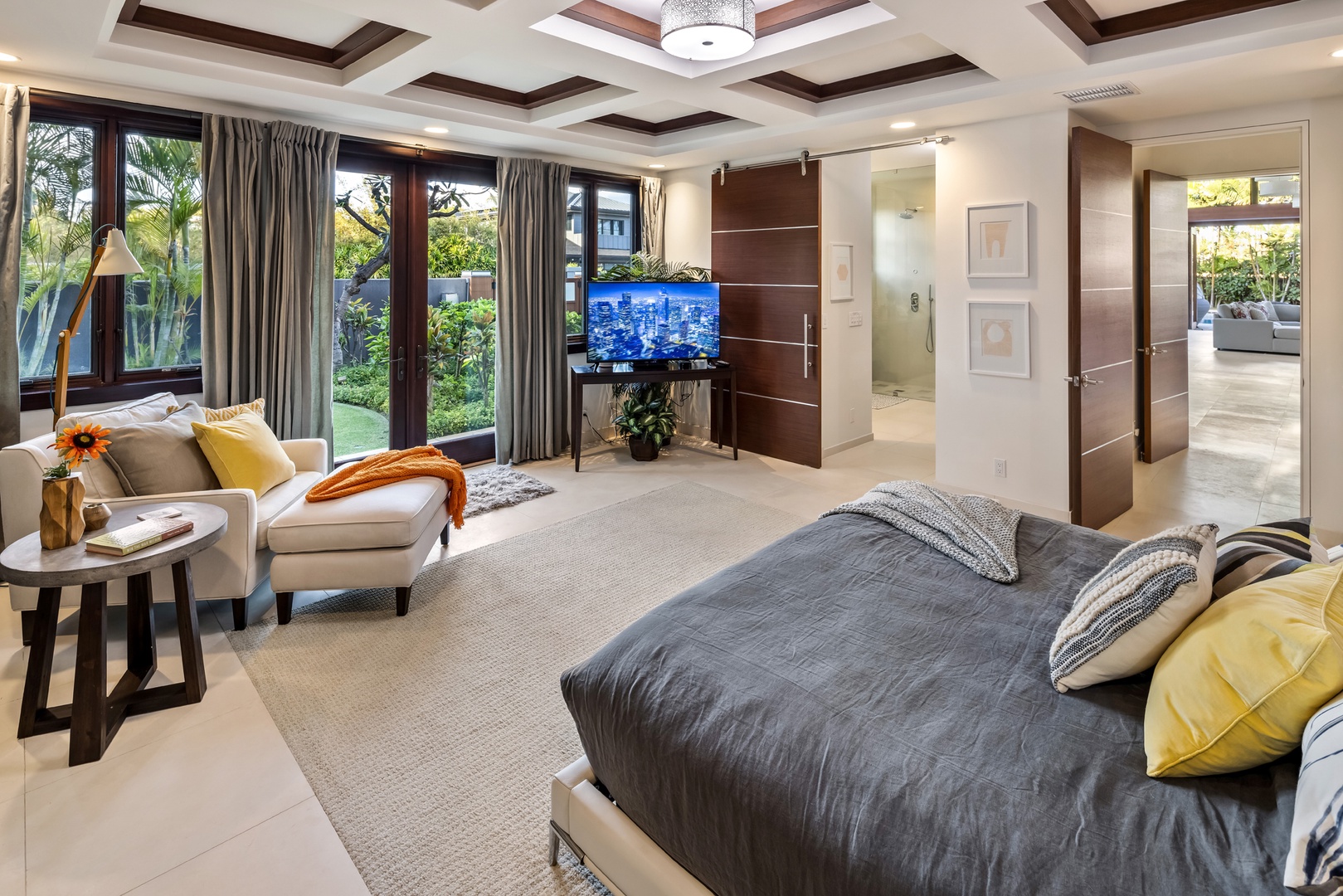 Honolulu Vacation Rentals, Kahala Grand Splendor - Cozy guest suite with a plush bed, TV, and serene outdoor views.