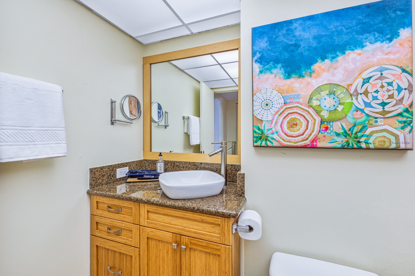 Lahaina Vacation Rentals, Kaanapali Shores 502 - The vibrant artwork complements the elegant vanity, featuring a sleek bowl sink and granite countertop. This bathroom is designed to be a bright and refreshing space