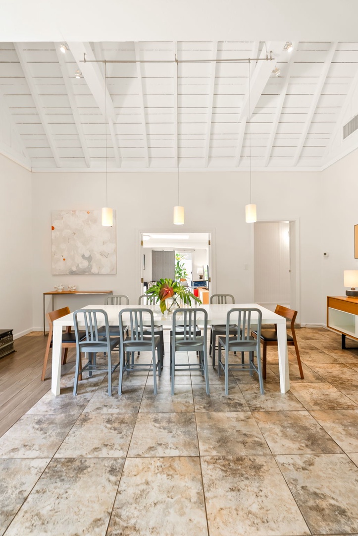Honolulu Vacation Rentals, Ho'okipa Villa - Gather around your spacious dining table under exposed white beams, where fresh flowers and soft pendant lighting create the perfect ambiance for memorable meals together.