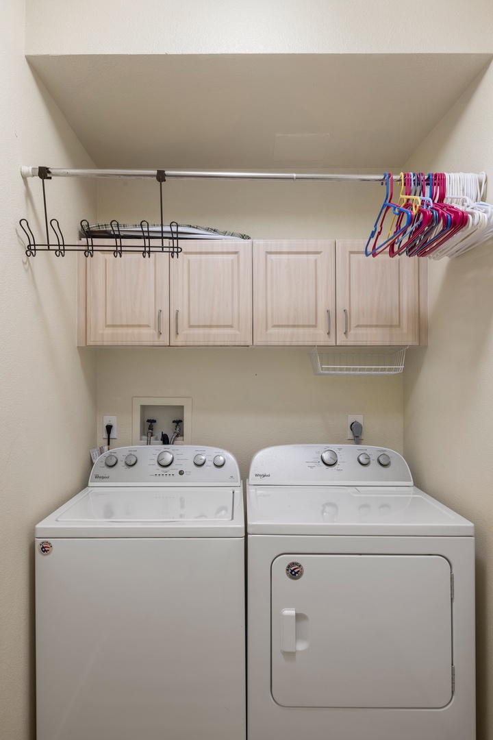 Keep your clothes fresh and organized in your private laundry space, complete with hanging storage above.