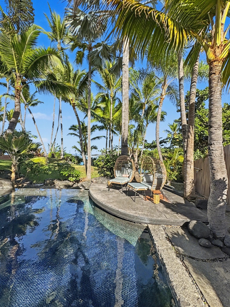 Kailua-Kona Vacation Rentals, Hahalua Bay Villa - Your private poolside paradise awaits beneath swaying palms, where two hanging chairs offer the perfect spot to unwind with tropical cocktails.