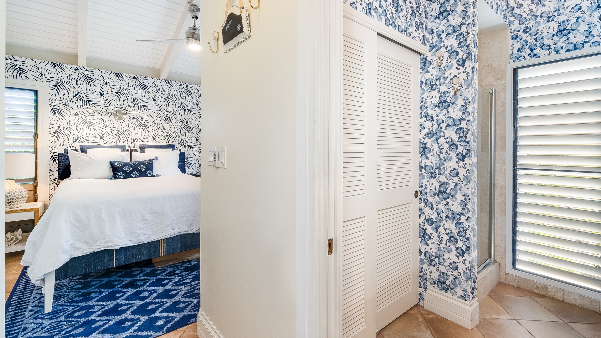 Kihei Vacation Rentals, Wailea Ekolu 1106 - A cozy hallway leads to a bedroom featuring vibrant blue accents and patterned wallpaper for a fresh, coastal feel.