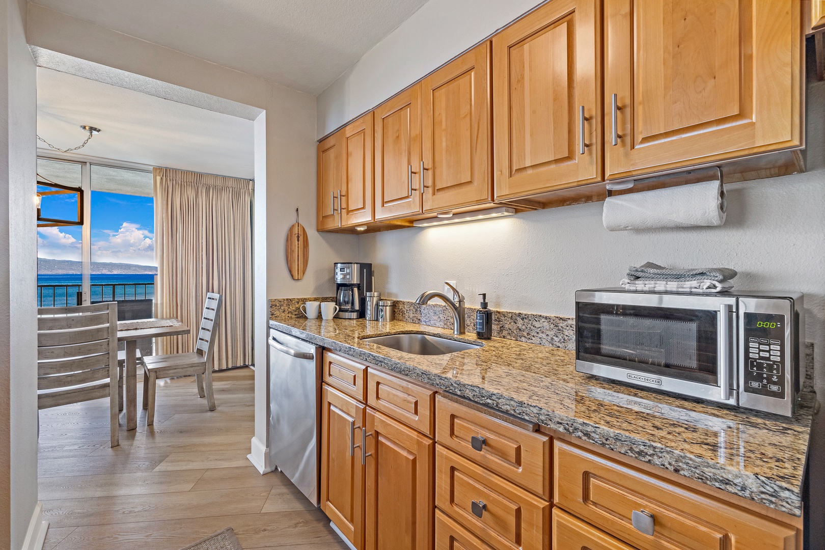 Lahaina Vacation Rentals, Royal Kahana 1010 - The kitchen is fully equipped with granite countertops and wooden cabinetry, offering everything you need to prepare meals during your stay.