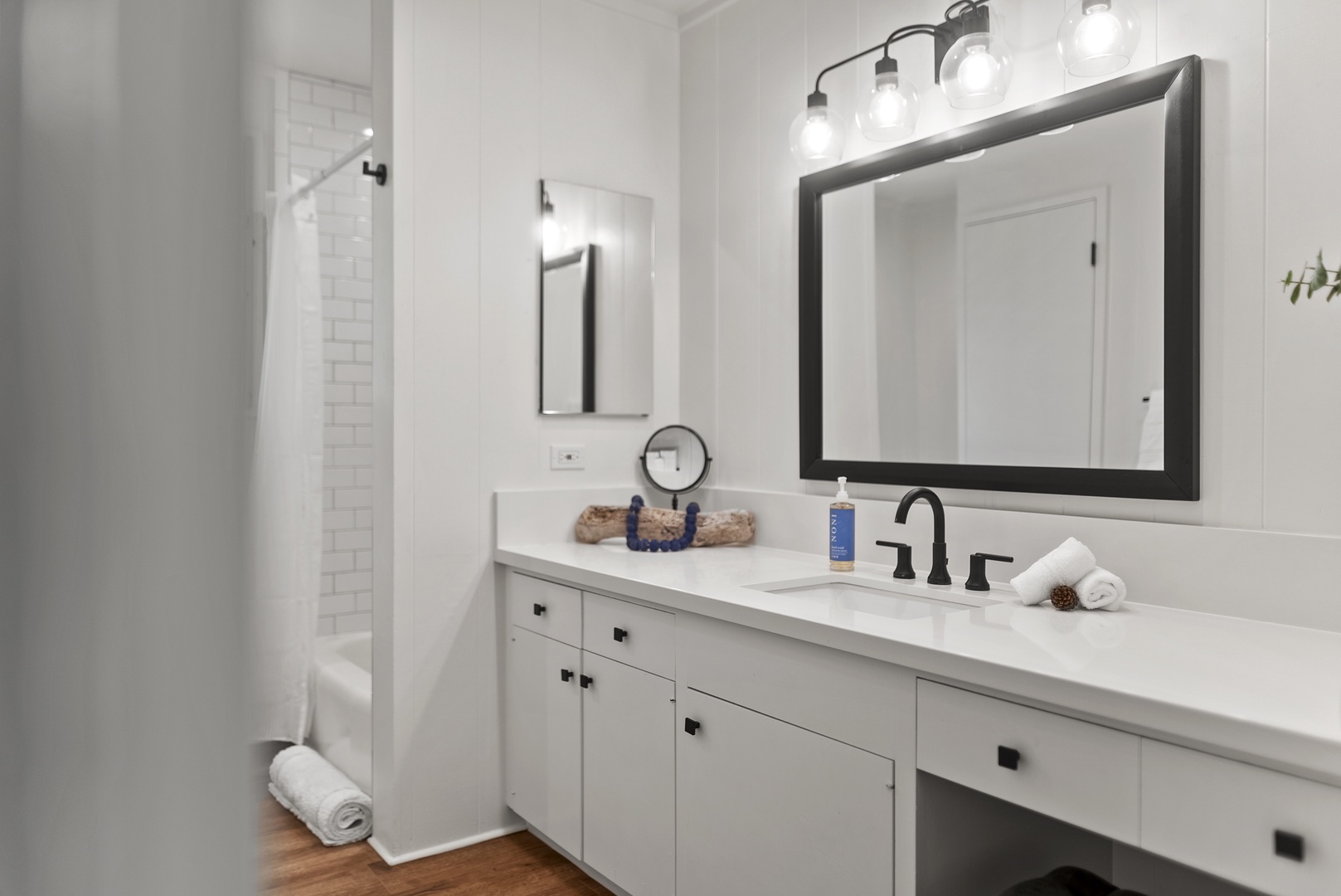 Honolulu Vacation Rentals, Honolulu Beachfront Retreat - Guest bathroom with a wide vanity and stylish finishes, making it easy for groups and families to share space.