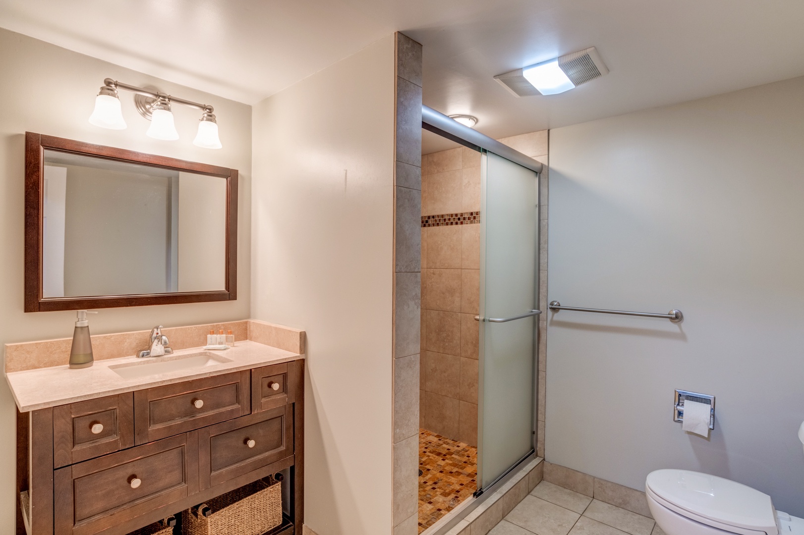 Kihei Vacation Rentals, Koa Resort 1B - Renovated bathroom with modern vanity and a walk-in tiled shower.