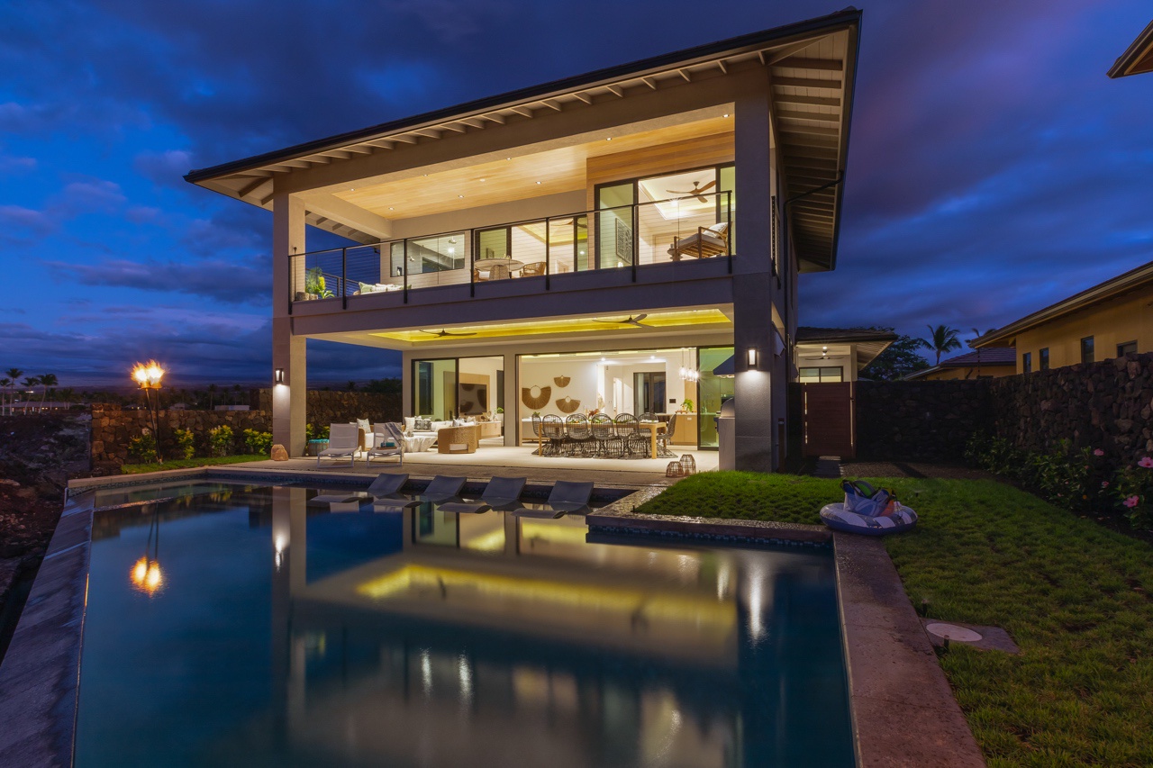 Waimea Vacation Rentals, 5BD Mauna Lani Lux Golf Estate (4) at One Ocean - As evening falls, this home transforms into a peaceful retreat with glowing interiors and a tranquil poolside setting.