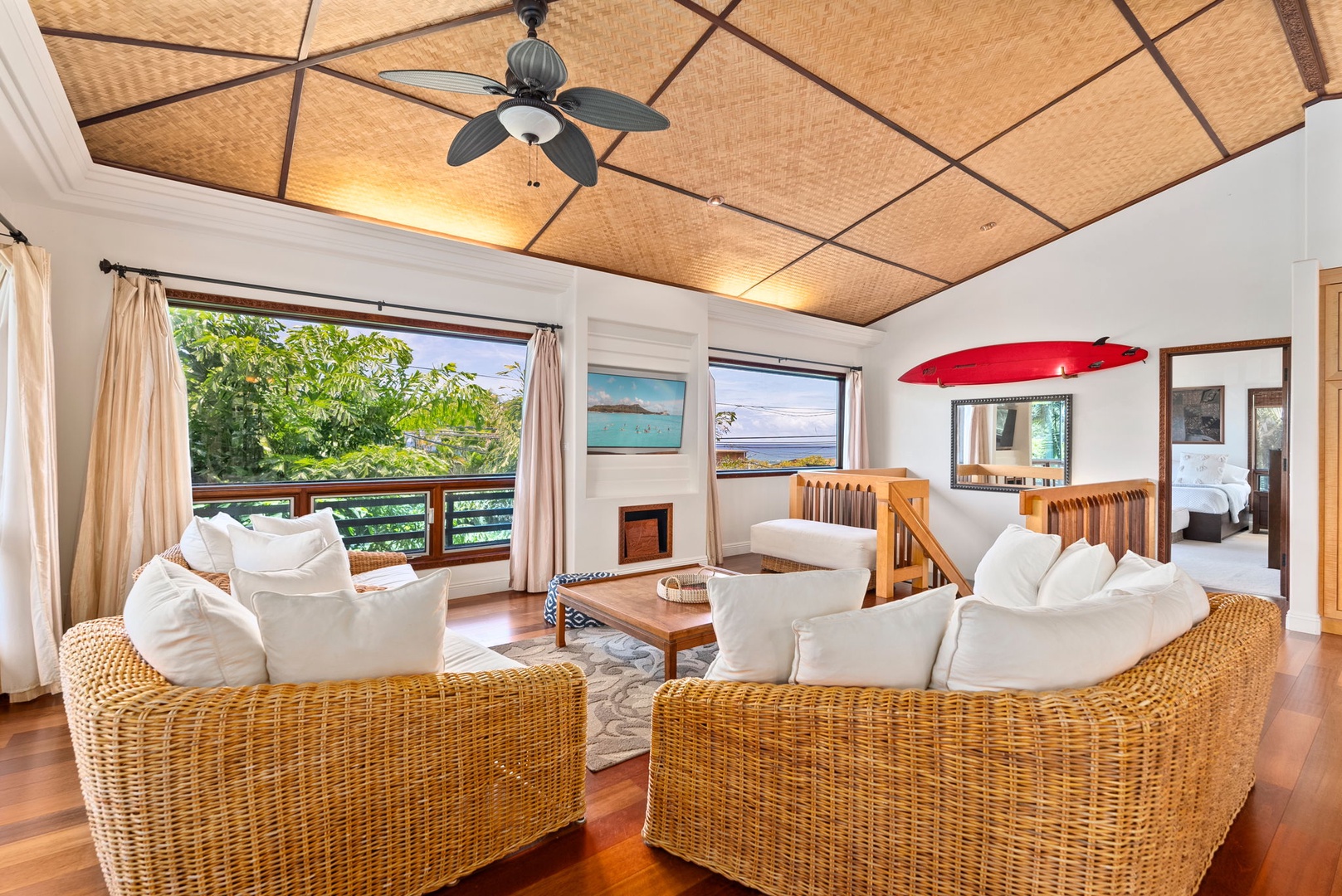 Haleiwa Vacation Rentals, Kealoha Tropical Beach Villa - The living area features seamless indoor-outdoor living with access to the spacious wrap-around deck, perfect for taking in the surrounding views.