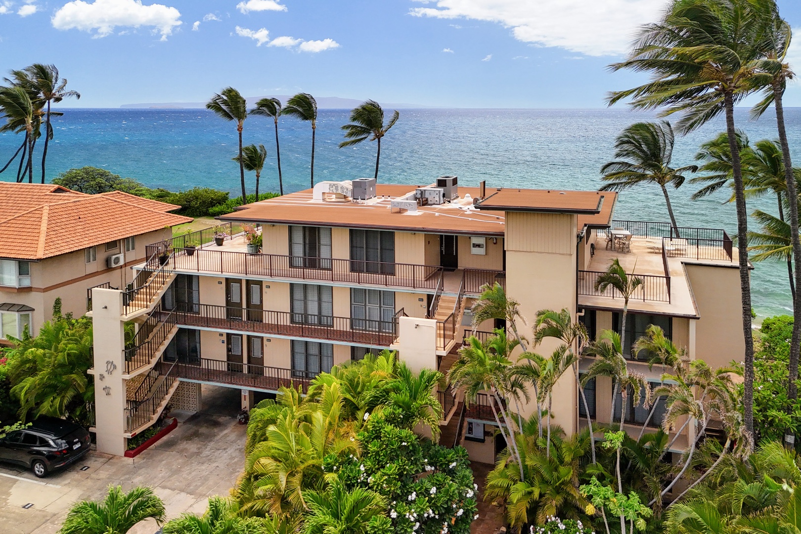 Kihei Vacation Rentals, Punahoa Beach 205 - An aerial look at the building with the Pacific opening up wide just beyond the rooftops.