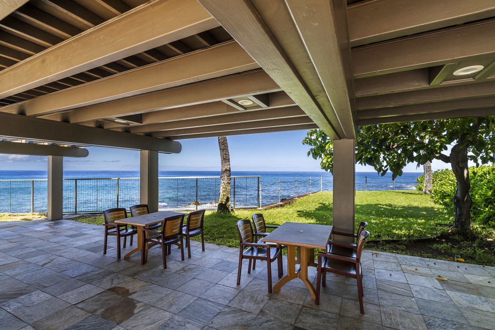Kailua Kona Vacation Rentals, Kanaloa at Kona 1606 - A shaded oceanfront pavilion with seating right at the water's edge.