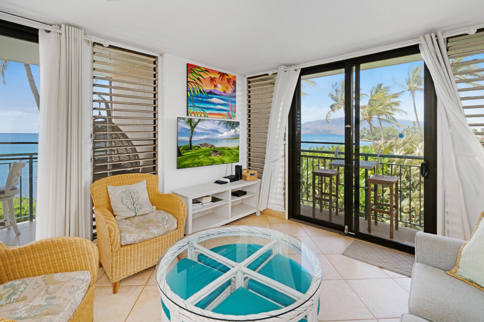 Kihei Vacation Rentals, Punahoa Beach 205 - The balcony chairs face open water, with mountains rising across the channel beyond.
