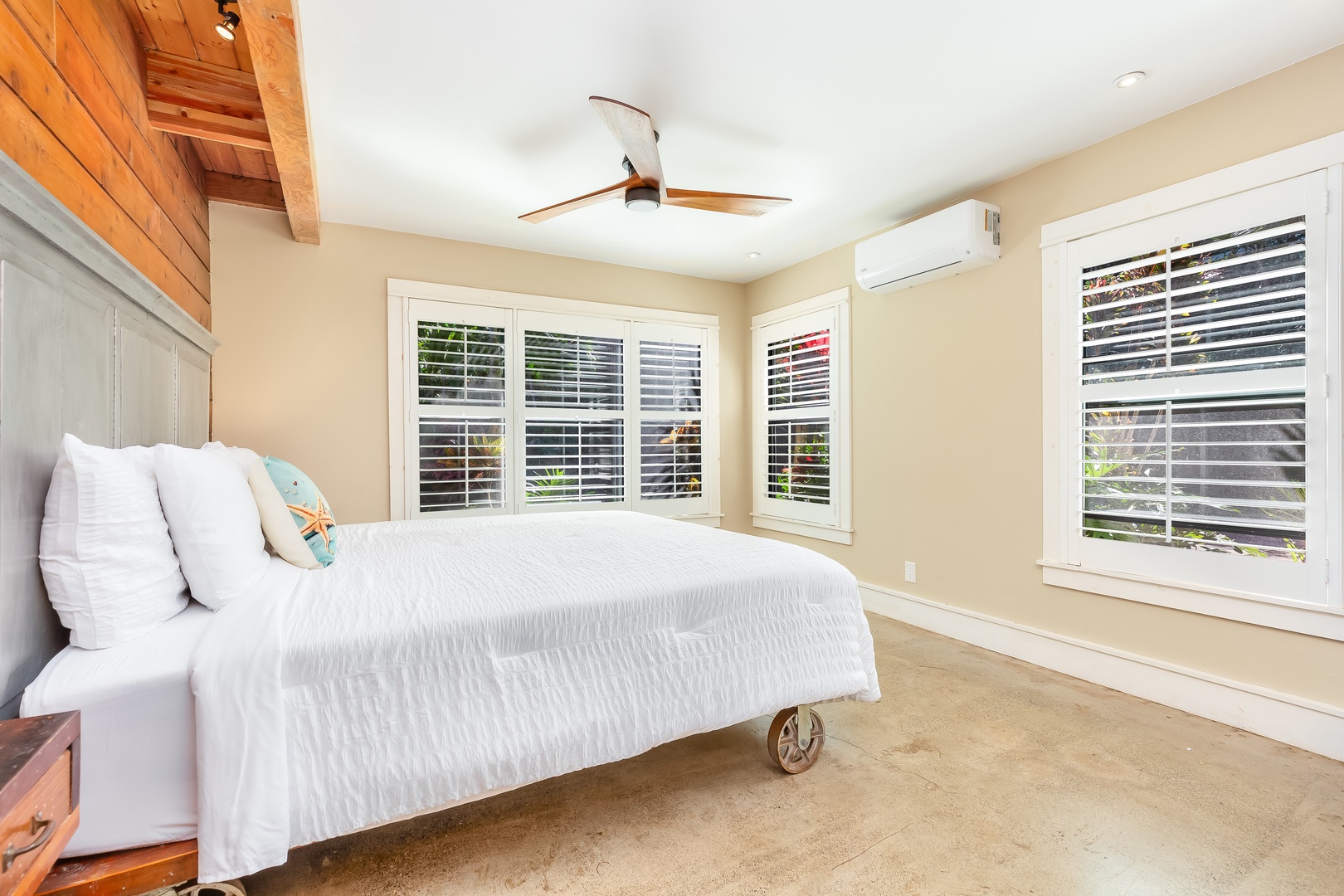 Haleiwa Vacation Rentals, Mele Makana - The primary bedroom is downstairs and has a king bed, ceiling fan, central A/C, and garden views