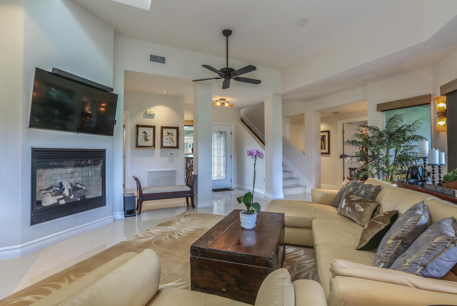 Princeville Vacation Rentals, Hale Moana - The living room is equipped with a ceiling fan and flat screen TV