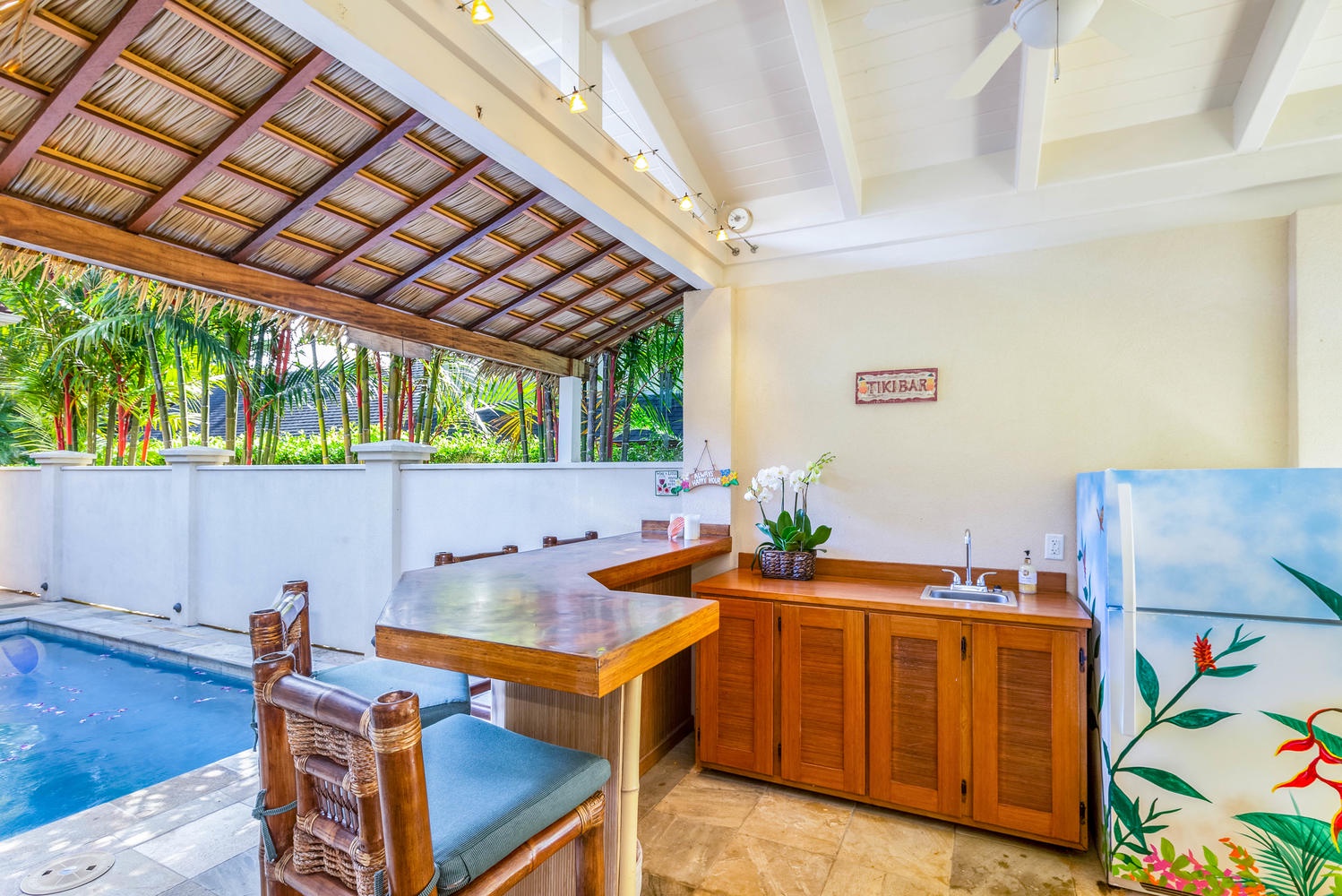 Princeville Vacation Rentals, Ohana Kamalani - Island-style tiki bar next to the pool offers the perfect setting for tropical drinks and poolside fun.