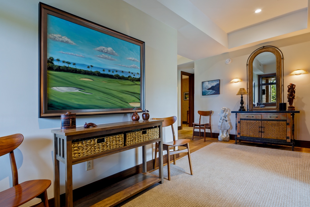 Kailua Kona Vacation Rentals, Fairways Villa 120A - Your elegant living space features warm wood furnishings, tropical golf artwork, and thoughtful lighting that creates the perfect atmosphere for relaxation.