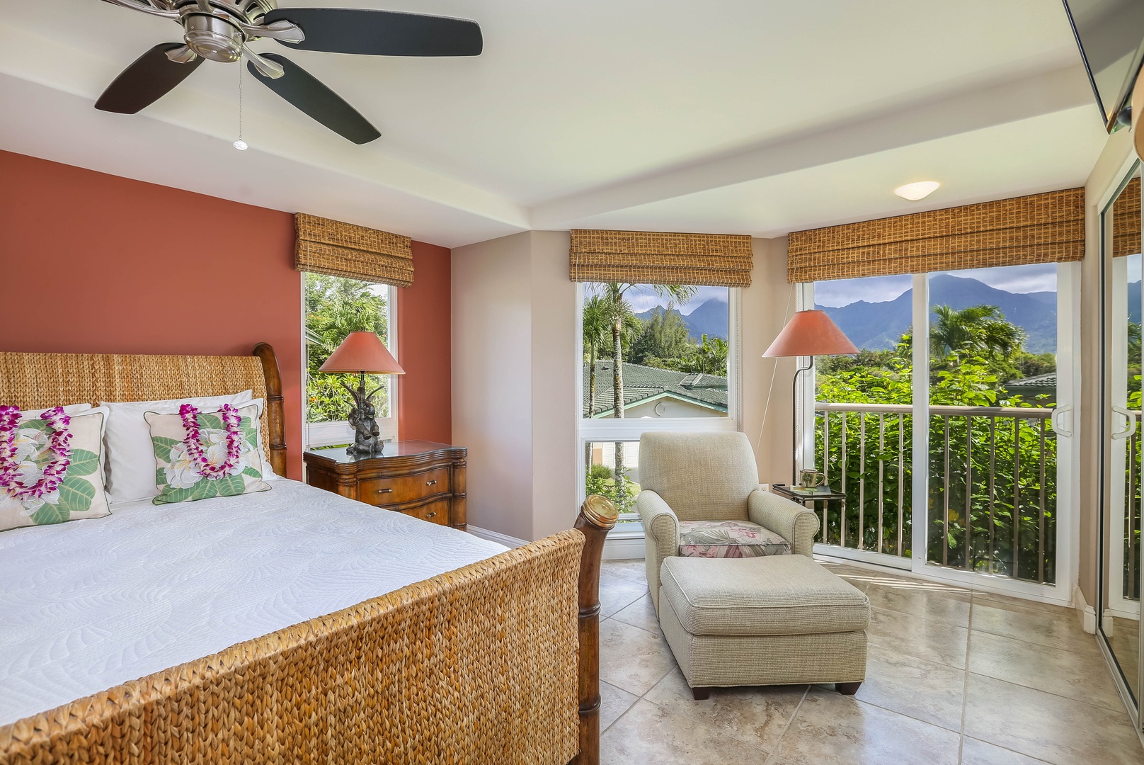Princeville Vacation Rentals, Nohea Villa - Bedroom suite with large windows, a ceiling fan, and a seating area.