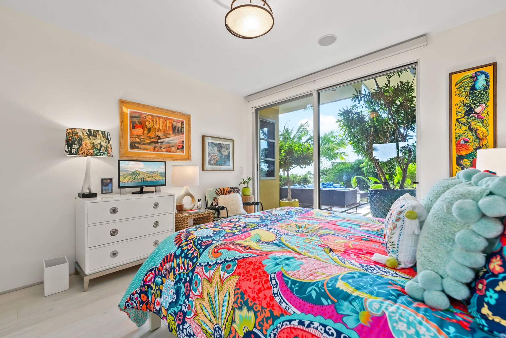 Honolulu Vacation Rentals, Kahala Hills Estate - Vibrant bedroom suite with king bed, lush views, and colorful island-inspired decor.