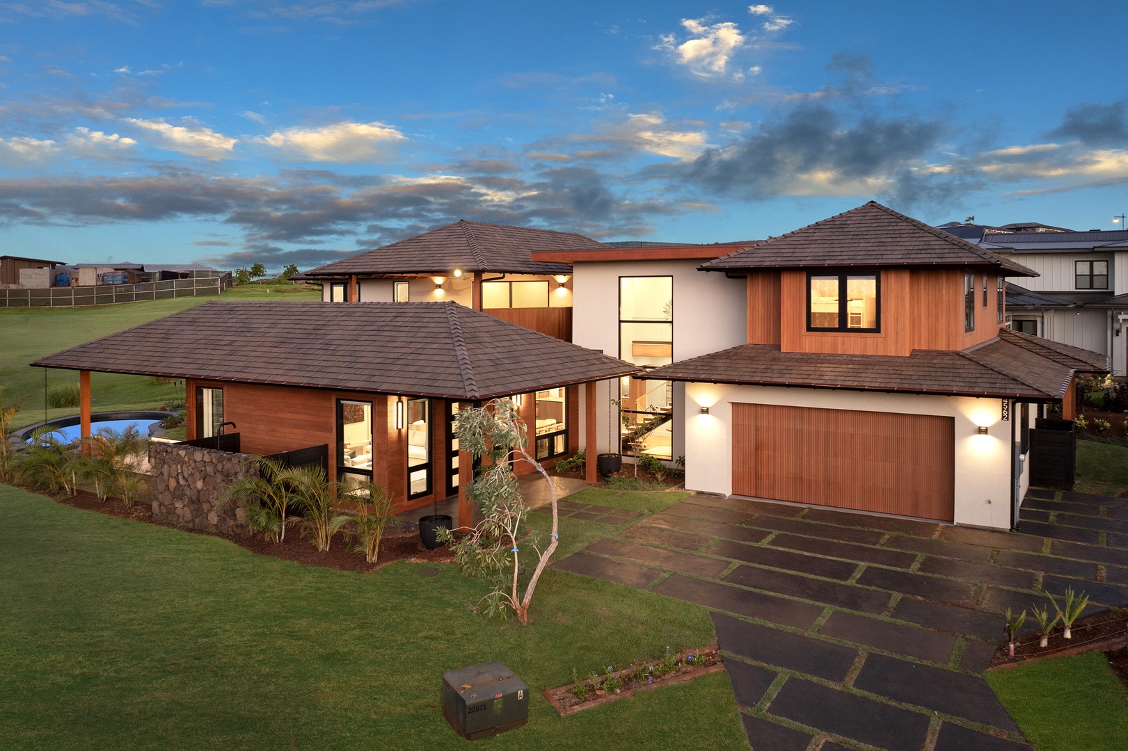 Koloa Vacation Rentals, Hale Hanohano - Aerial view of the private estate surrounded by greens and ocean horizon.