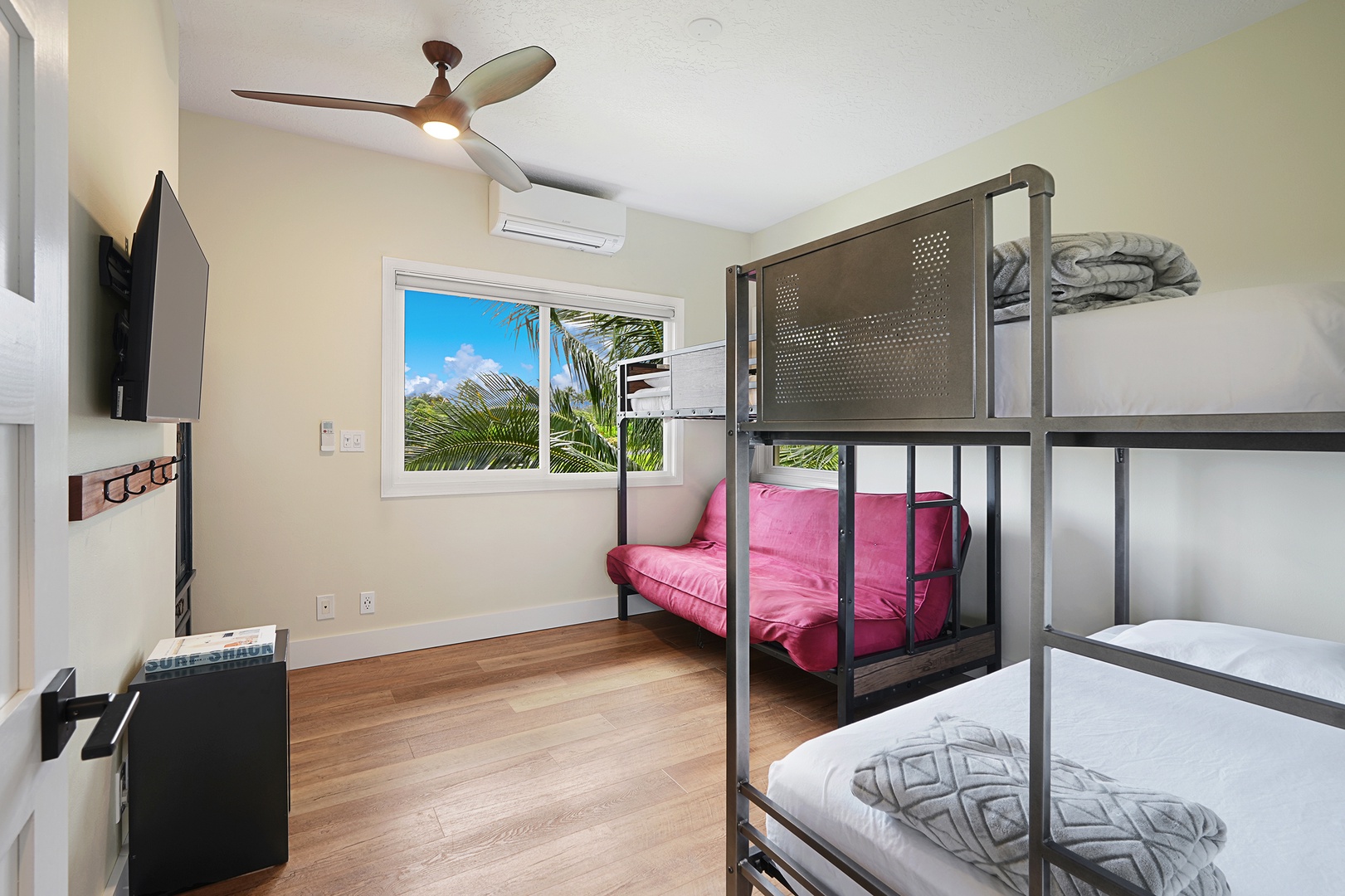 Princeville Vacation Rentals, Pohaku Villa - Your cozy bedroom features comfortable bunk beds, air conditioning, and a TV for relaxing after tropical adventures.