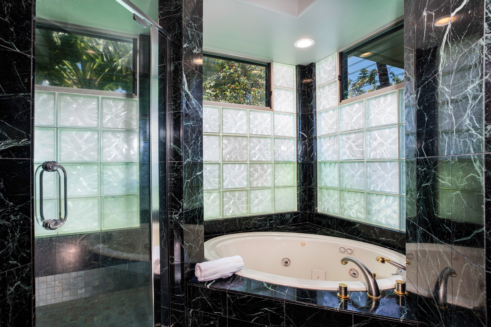 Kamuela Vacation Rentals, Canoe House at Champion Ridge - Jetted spa tub in a serene corner with glass-block light and privacy.