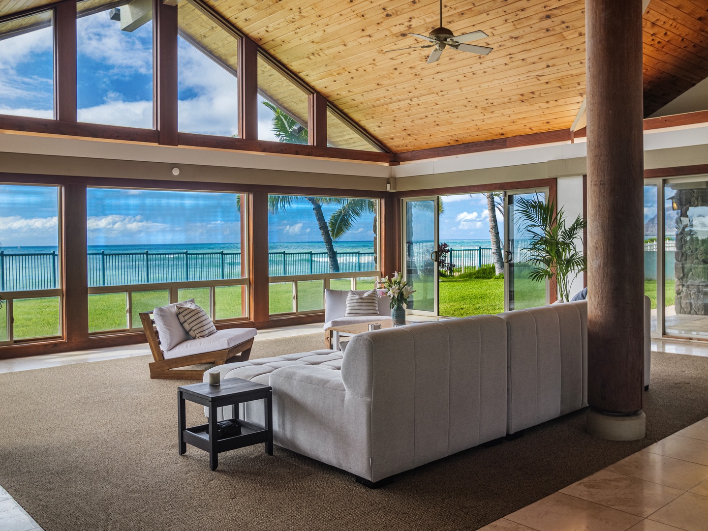 Waianae Vacation Rentals, Konishiki Beachhouse - Elegant living room with plush seating, ocean views, and a warm, inviting atmosphere.
