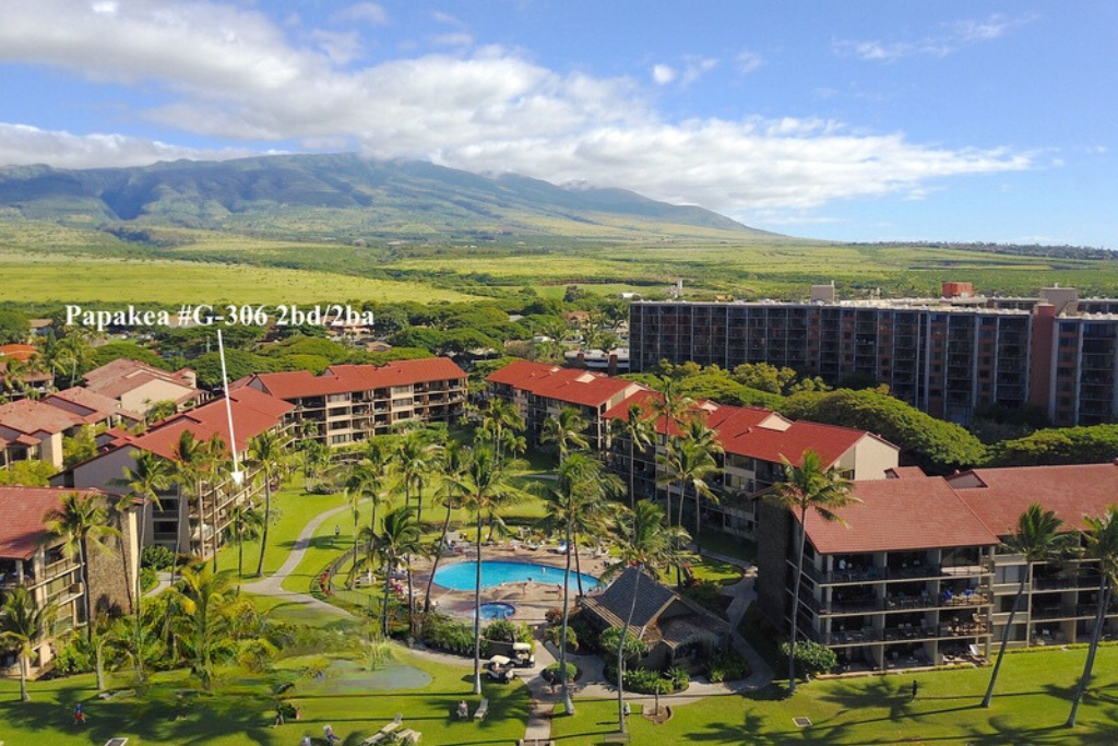 Lahaina Vacation Rentals, Papakea G-306 - This aerial view showcases the expansive resort grounds, featuring the pool, tropical landscaping, and breathtaking mountain views in the distance.