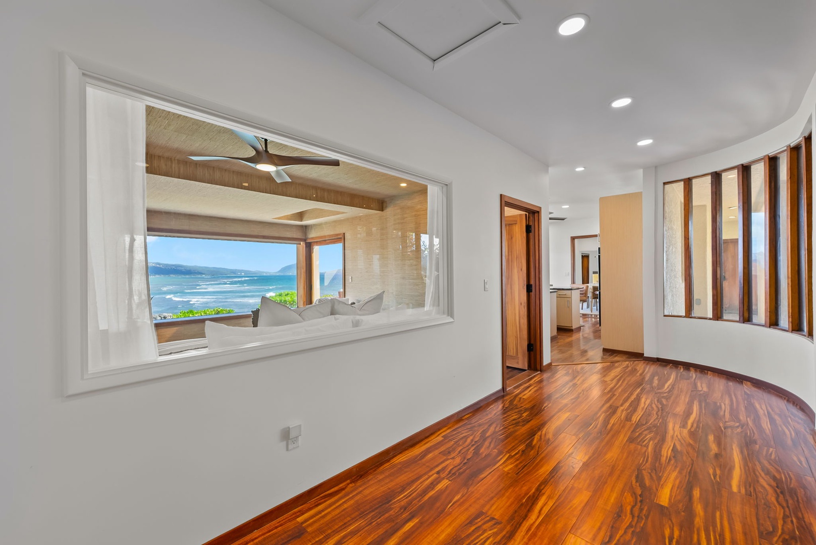 Honolulu Vacation Rentals, Black Point Ocean Villa - Stunning ocean views through your bedroom's picture window, where gleaming hardwood floors meet coastal luxury in this serene retreat.