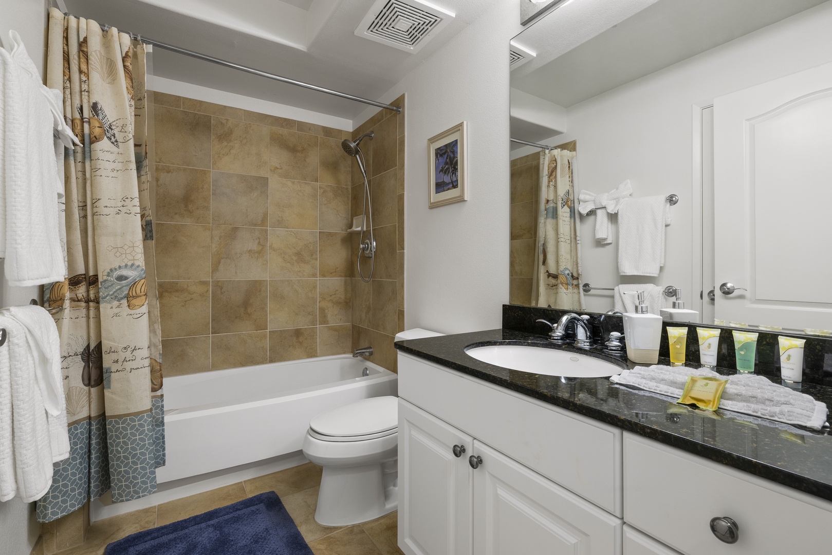 The full bathroom features a spacious vanity and tub-shower combination, offering comfort and convenience throughout your stay.
