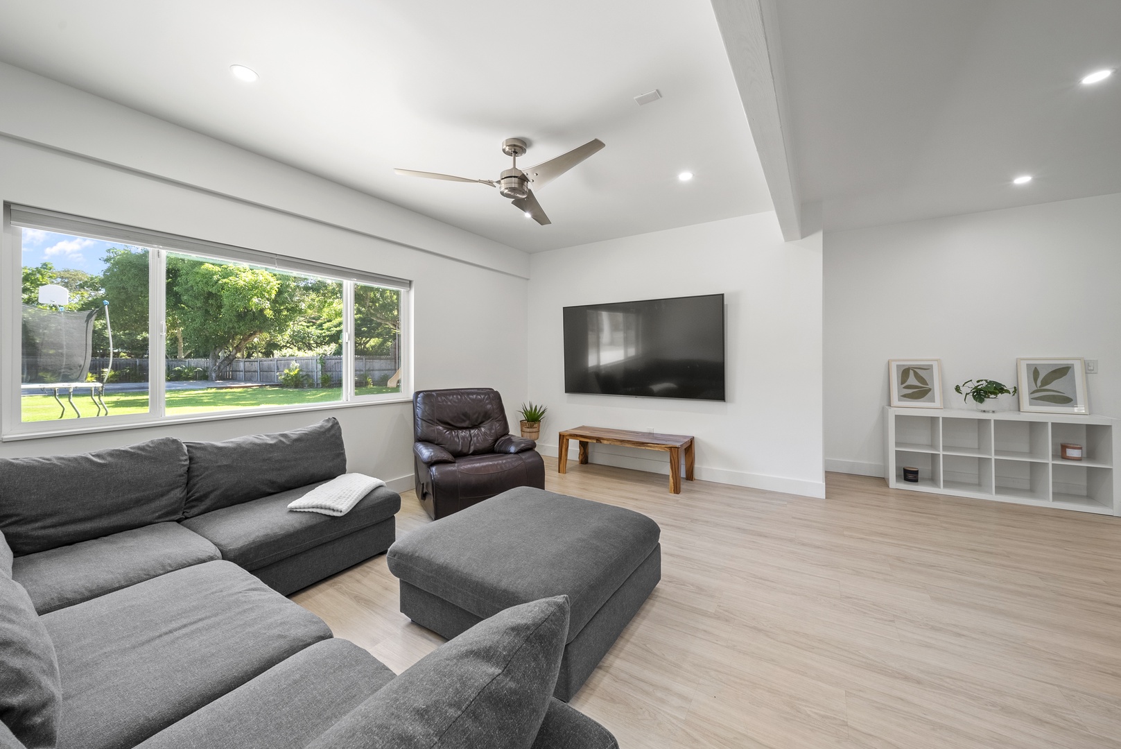 Haleiwa Vacation Rentals, Sunset Beach Island Retreat - The downstairs open concept bedroom features a sleek entertainment center with a flat-screen TV