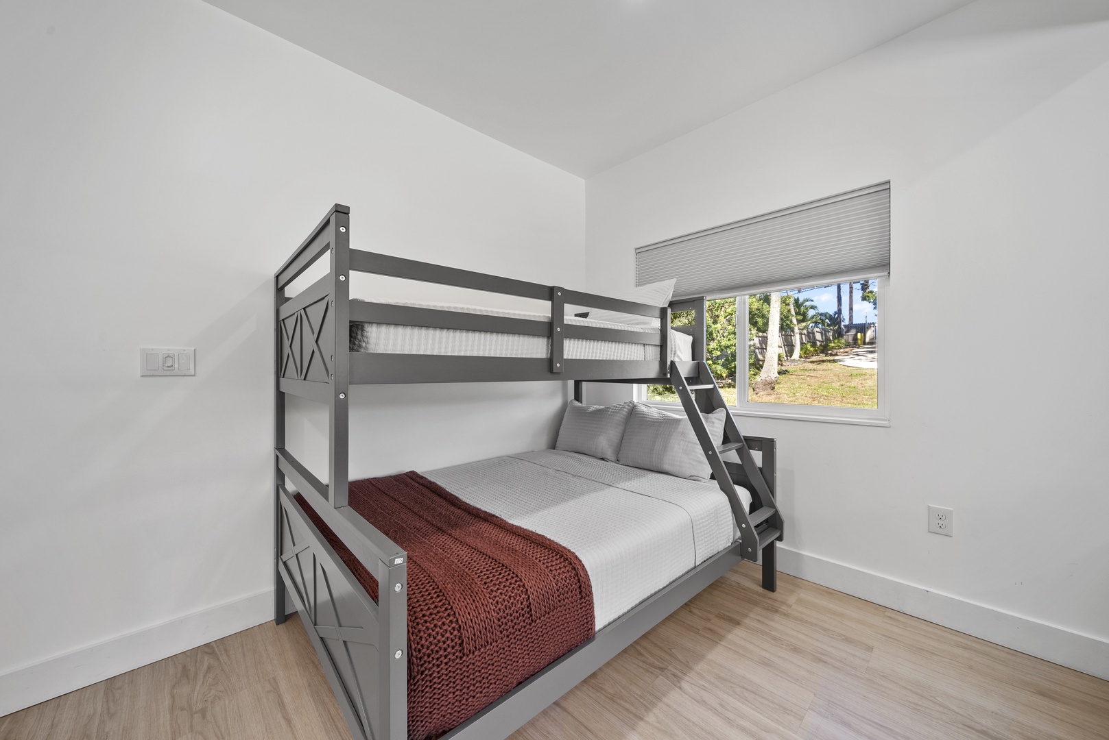 Haleiwa Vacation Rentals, Sunset Beach Island Retreat - The downstairs bedroom features a twin over queen bunk beds, providing flexible sleeping arrangements for guests of all ages.