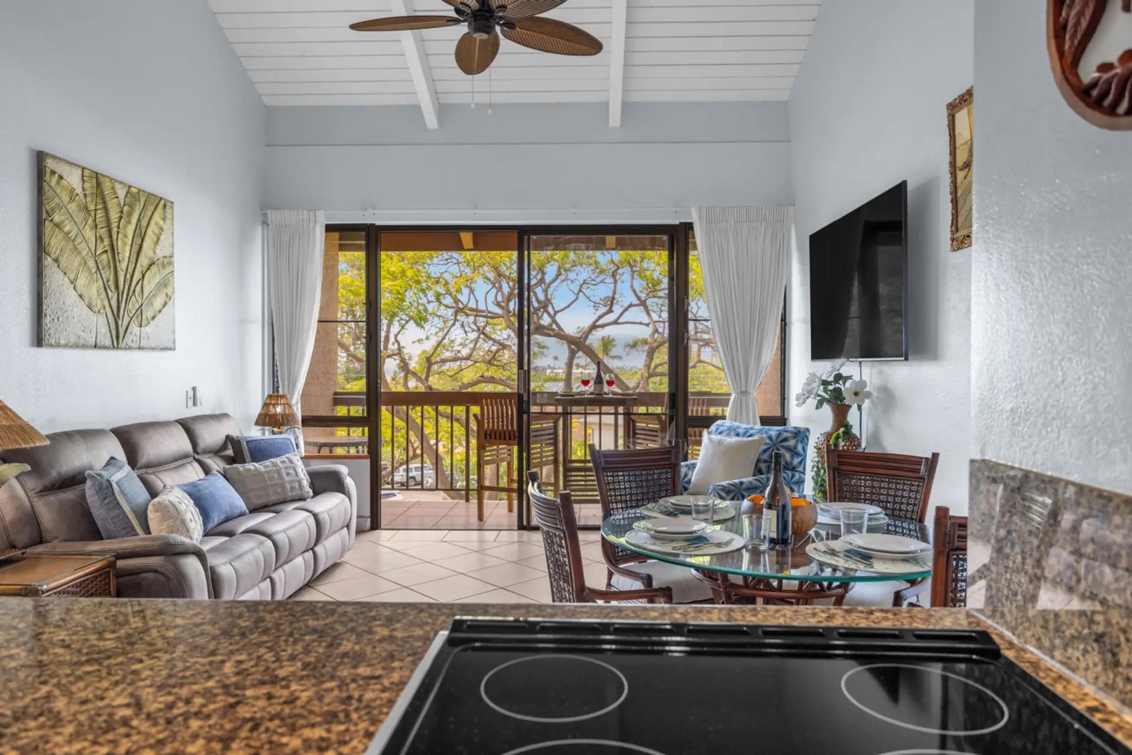 Kihei Vacation Rentals, Maui Vista 2420 - From the kitchen, the living and dining rooms open straight through sliding doors to the leafy lanai.