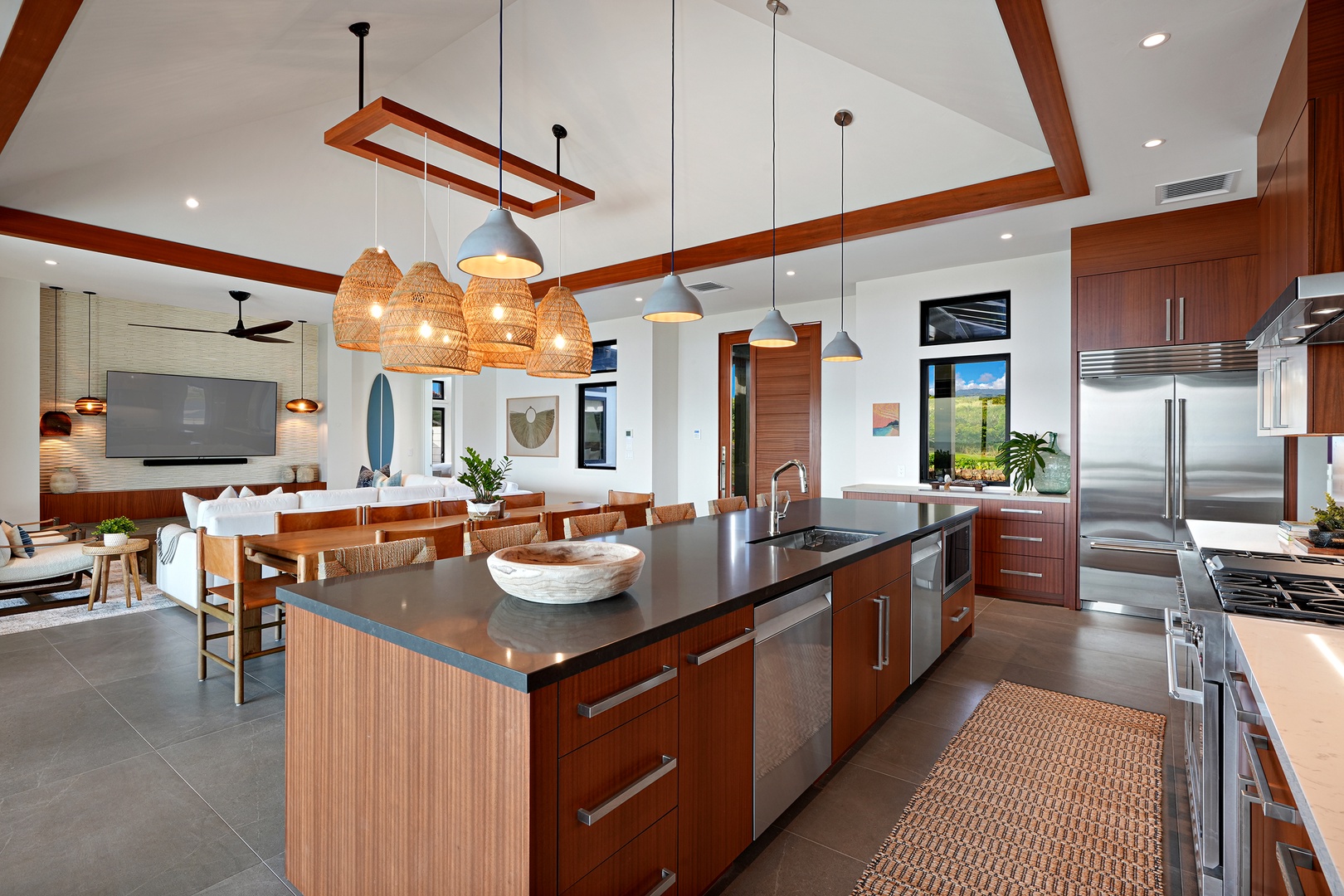 Koloa Vacation Rentals, Hiki Moe Hale - Gather in the spacious kitchen with a large island, sleek appliances, and modern lighting.